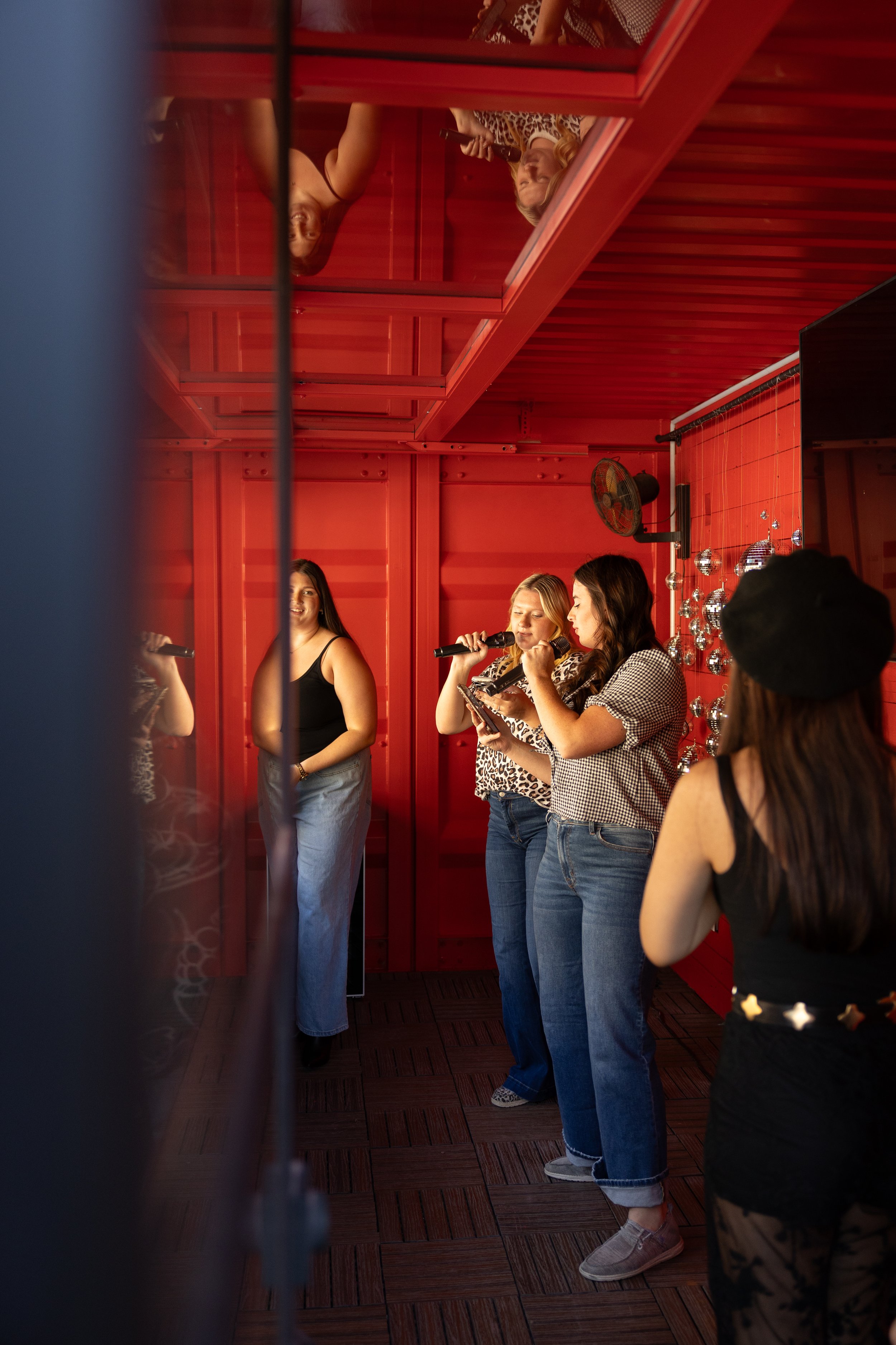 Guests singing karaoke in the entertainment room at The Penrose House